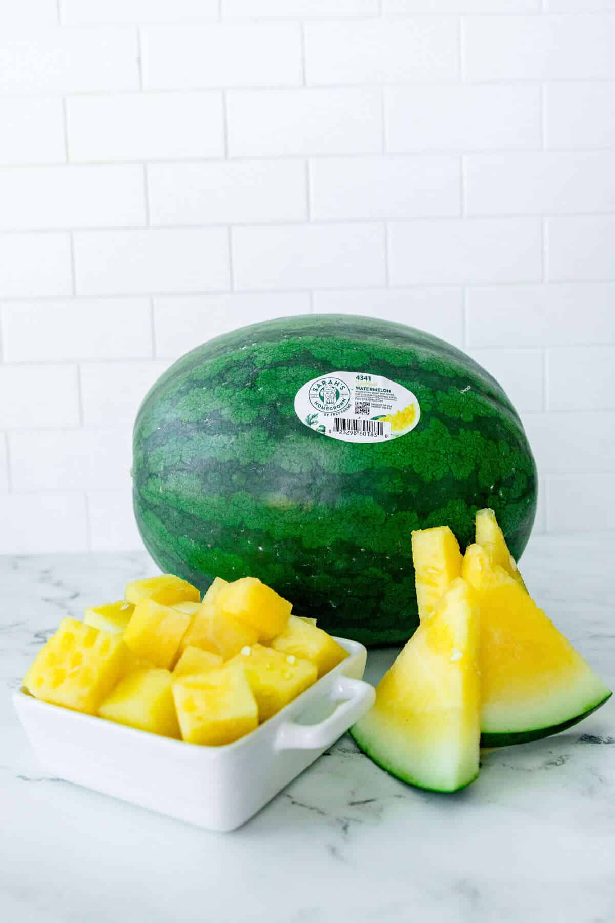 Whole yellow watermelon, sliced watermelon wedges, and cubed watermelon pieces showcasing the fruit&rsquo;s golden interior and use as a sustainable summer snack.