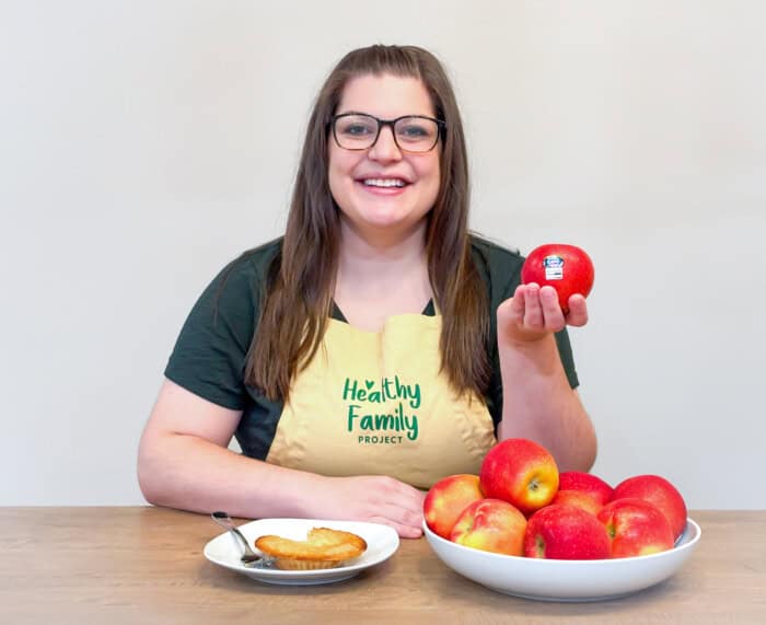 Registered Dietitian holding a Kanzi Apple
